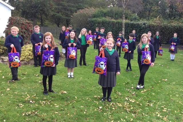 Ballycarry Prirmary School pupils with their early Halloween treats.