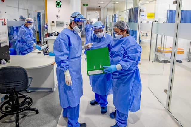 Health workers wearing full personal protective equipment (PPE) on an intensive care unit (ICU). (Photo: PA Wire)