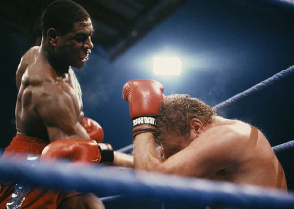 Heavyweight boxer Frank Bruno (left) on the attack in the 8th round during his fight against Joe Bugner on 24th October 1987 at White Hart Lane, London. (Photo by Russell Cheyne/Getty Images).