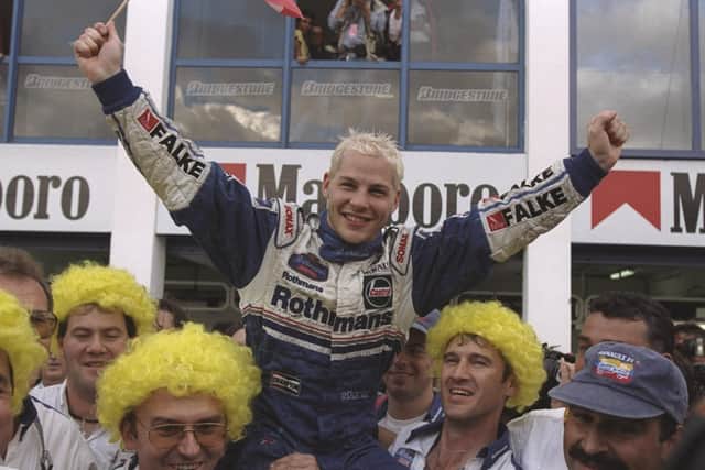 Williams-Renault driver, Jacques Villeneuve of Canada celebrates with the Williams team after the European Grand Prix in Jerez, Spain. Villeneuve finished third in the race and won the Drivers Championship in 1997. Picture: Mark Thompson/Allsport.