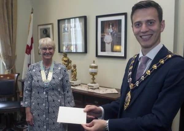 The Mayor of Mid and East Antrim, Councillor Peter Johnston, presents a cheque to Patricia Perry, the new District Chairman of Inner Wheel District 16, which covers the whole of Ireland