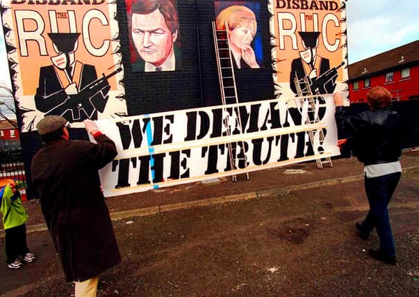 A mural being painted in 1999 demanding 'the truth' about the  murder of Pat Finucane (and Rosemary Nelson)