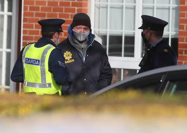 Gardai at a house on the Llewellyn estate in Ballinteer, south Dublin, following the discovery of bodies of a woman and two young children.