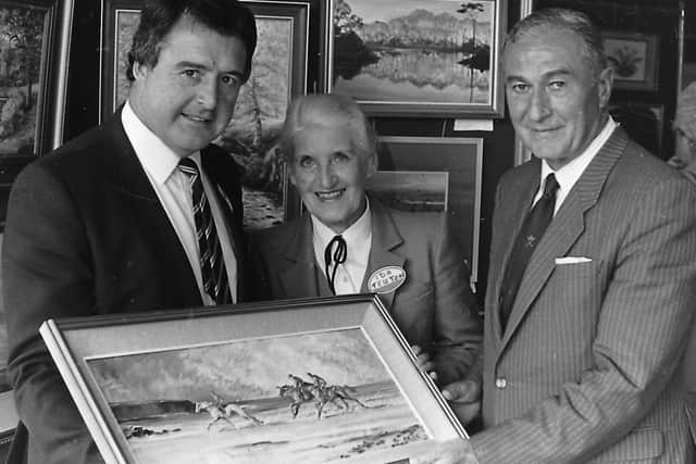 Admiring a painting by Lady Kinahan at the Collegians Art Show in October 1987 are Peter Jones, president of the club, artist Ida Teuton and Willoughby Wilson, president of the Ulster Branch of the Irish Rugby Football Union. Picture: News Letter archives