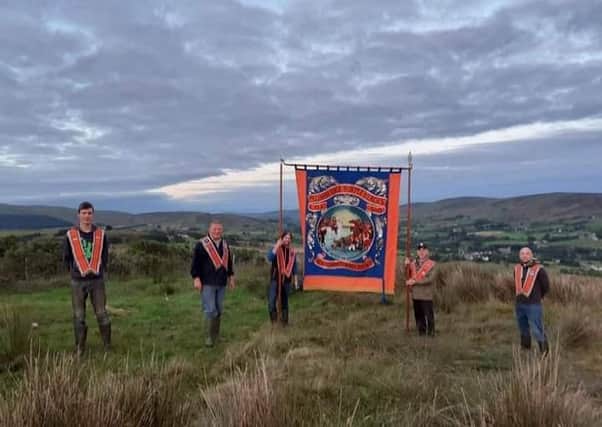 Pictured are members of Plumbridge LOL 560 with their banner, which they took to the top of Letterbrat Hill, overlooking the village, on the Eleventh Night