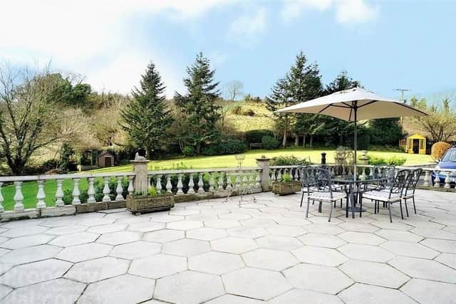 The exterior paved terrace overlooking the gardens