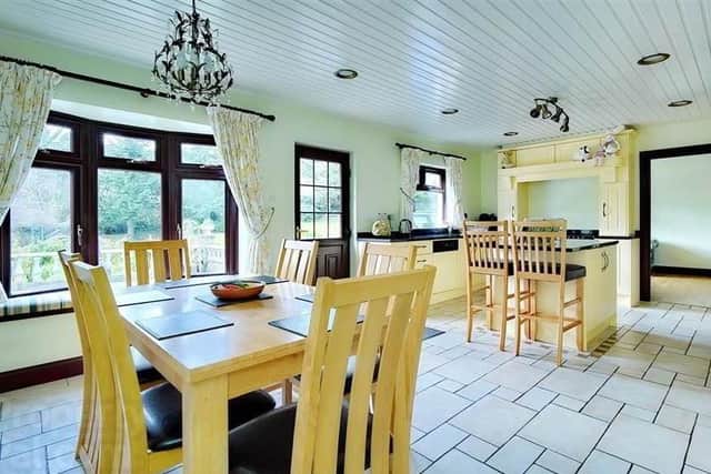 The property has an open plan kitchen - dining leading to an exterior paved terrace overlooking the gardens