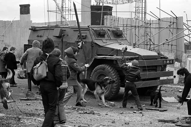 Youths bombarding an Army Saracen at a junction on Belfast's Whiterock Road