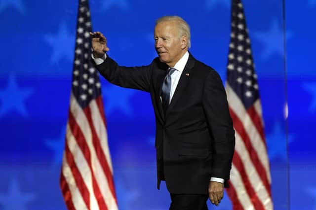 Democratic presidential candidate former Vice President Joe Biden waves to supporters late on Tuesday (early Wednesday in UK time) in Delawre. He said he was on course to win, but unlike Donald Trump he did not claim victory (AP Photo/Andrew Harnik)