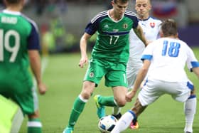 Northern Ireland's Paddy McNair withSlovakia's Dusan Svento  in a match between the countries in 2016. They play again at football today. But how do the economies of the two match up? Pic William Cherry Presseye