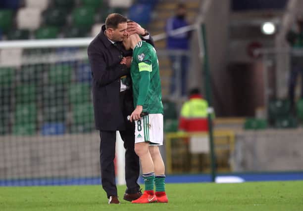 Northern Ireland manager Ian Barraclough consoles the team captain, Steven Davis after the 2-1 defeat to Slovakia in the European championship final qualifying match at the National stadium. PICTURE BY STEPHEN DAVISON