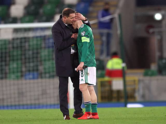 Northern Ireland manager Ian Barraclough consoles the team captain, Steven Davis after the 2-1 defeat to Slovakia in the European championship final qualifying match at the National stadium. PICTURE BY STEPHEN DAVISON