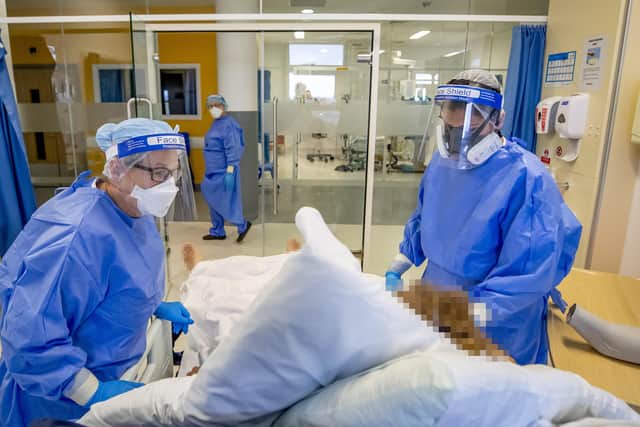 Medical staff attending to a Covid-19 patient in an intensive care unit.