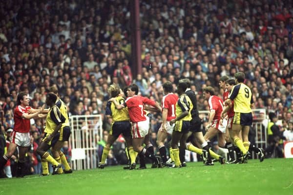 Manchester United and Arsenal players fight on the pitch during the Barclays League Division One match at Old Trafford in Manchester, England. Arsenal won the match 1-0. Photo: Russell Cheyne/Allsport.