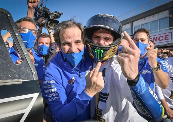Joan Mir and Suzuki team manager Davide Brivio celebrate winning the 2020 MotoGP World Championship.