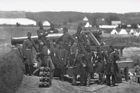 Union soldiers pose for a photograph with a cannon during the American Civil War.  one of the earliest true industrial wars. Railroads, the telegraph, steamships, and mass-produced weapons were employed extensively