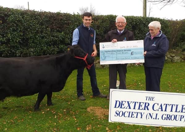 Ryan Lavery , Chair of Dexter Cattle NI Group,  presenting cheque from the group to Southern Area Hospice Representitives Neville and Myrtle Pogue