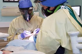 A dentist in full PPE gear during the coronavirus pandemic. They report that enhanced PPE such as this is exhausting to wear as it is so restrictive on breathing.