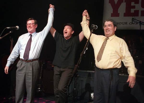 19/05/98: David Trimble, U2 frontman Bono, and John Hume on stage at the Waterfront Hall in Belfast to promote a YES vote in the referendum