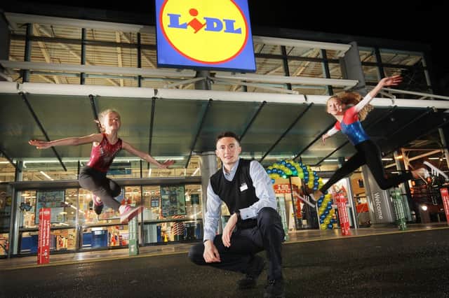 Pictured opening the store (L-R) are Sophie Kingston, Queens Gymnastics, Eoin Doherty, Holywood Exchange Store Manager and Isla Parkes, Queens Gymnastics