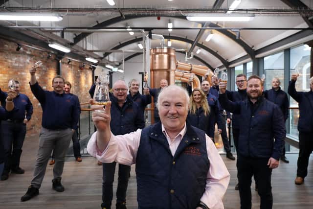 Chairman of Hinch Distillery Dr Terry Cross OBE (centre) and his team