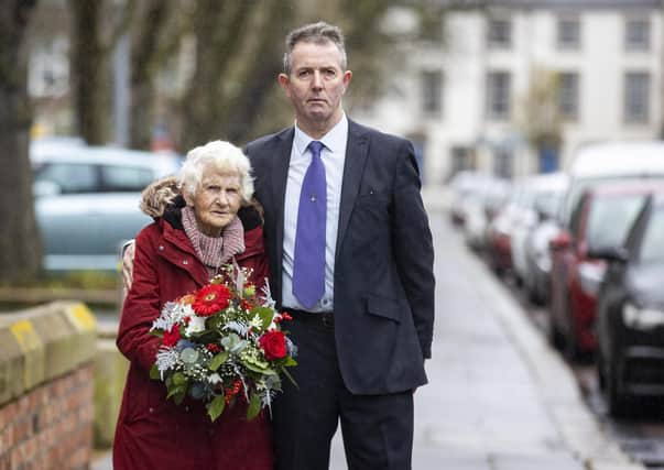 Maura Babington, widow of James Henry Babington, with their son Marcus during a wreath laying on University Square with students from Queen's University Belfast, ahead of the anniversary of the murder of Edgar Graham.