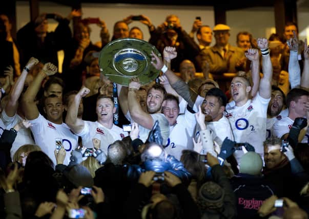 England's Captain Chris Robshaw (C) lifts the Hillary Shield after defeating New Zealand in the international rugby union match at Twickenham Stadium, southwest of London, on December 1, 2012. England won the game 38-21 ending New Zealand's 20-game unbeaten run. Photo: ADRIAN DENNIS/AFP via Getty Images).
