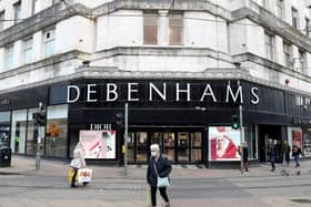 People walk past Debenhams on Market Street in Manchester. Administrators have "regretfully" decided to start winding down operations while continuing to seek offers for all or parts of the business, after JD Sports confirmed it had pulled out of a possible rescue deal, putting 12,000 workers at risk.