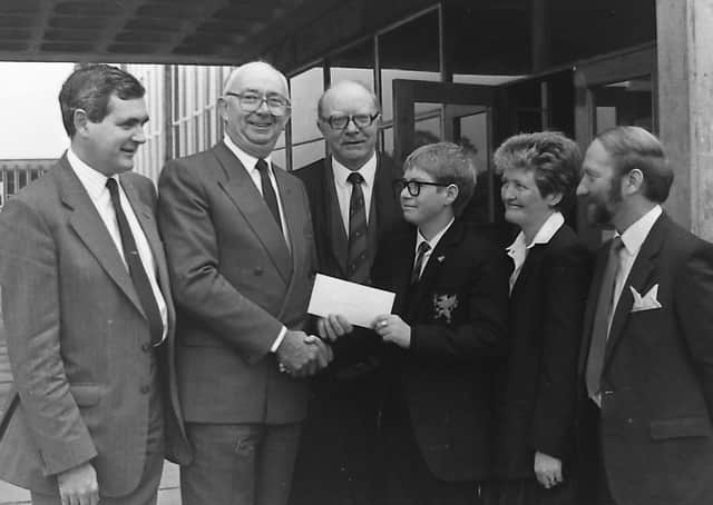 Pictured in October 1989 is the chief executive of Northern Ireland Railways Roy Beattie presents first prize in the 150th Anniversary of Rail in Ulster competition, a trip to Dublin on the Enterprise, to Stephen Forsyth, 14, of Gransha Boys' High School, Bangor. Included is headmaster Bob McCullough and Stephen's mum and dad, Tracey and Roy. Picture: News Letter archives