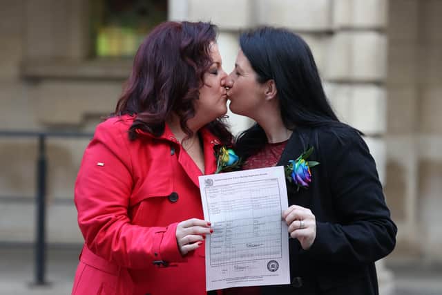 Amanda McGurk (left) and Cara McCann outside Belfast City Hall after becoming the first couple in Belfast to convert their civil partnership into a marriage