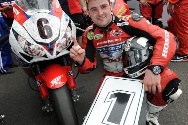 Michael Dunlop celebrates winning the Superbike race at the Isle of Man TT in 2013.
