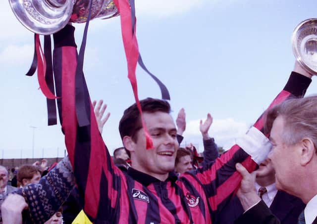 Glenn Dunlop with the league-winners cup in 1997; today he is a Christian pastor