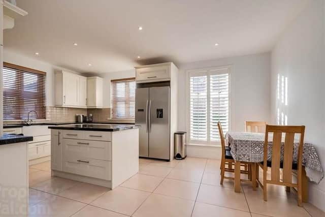 The property has a modern fitted kitchen with dining area