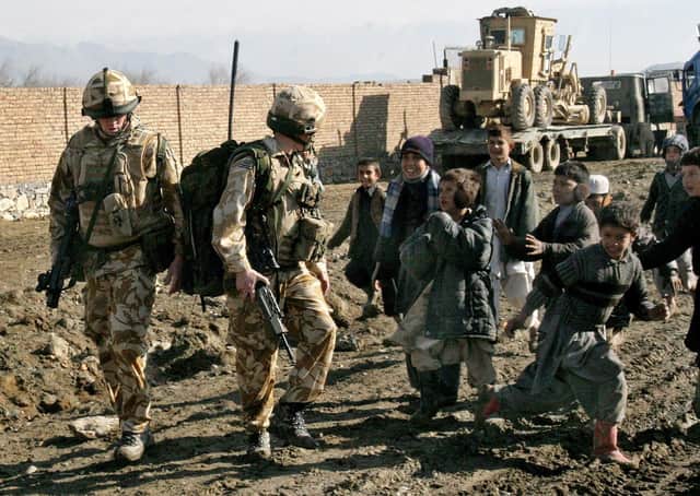 British soldiers of the NATO-led forces meet a group of Afghan boys during a routine foot patrol in Kabul, Afghanistan in February 2007. Picture:  AP Photo/Musadeq Sadeq