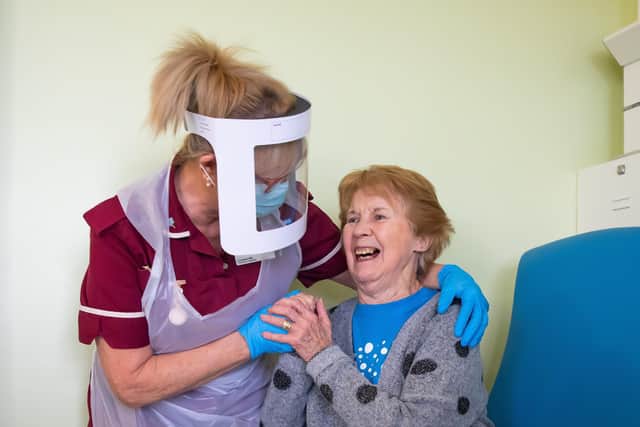 Margaret Keenan, 90, the first patient in the United Kingdom to receive the Pfizer/BioNtech covid-19 vaccine, with Healthcare assistant Lorraine Hill, preparing to leave University Hospital, Coventry, Warwickshire, the day after receiving the first of two doses of the vaccine.