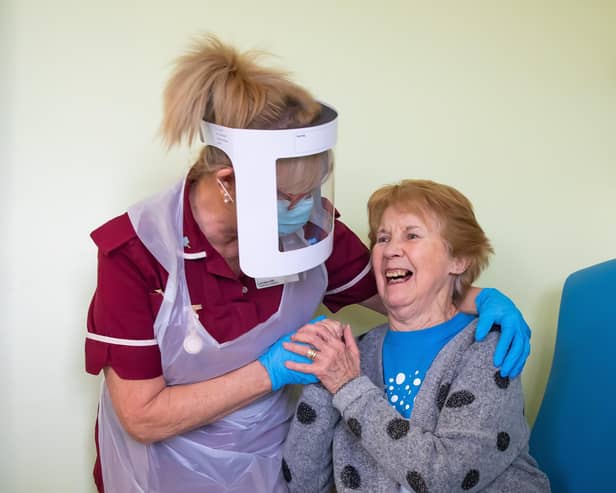 Margaret Keenan, 90, the first patient in the United Kingdom to receive the Pfizer/BioNtech covid-19 vaccine, with Healthcare assistant Lorraine Hill, preparing to leave University Hospital, Coventry, Warwickshire, the day after receiving the first of two doses of the vaccine.