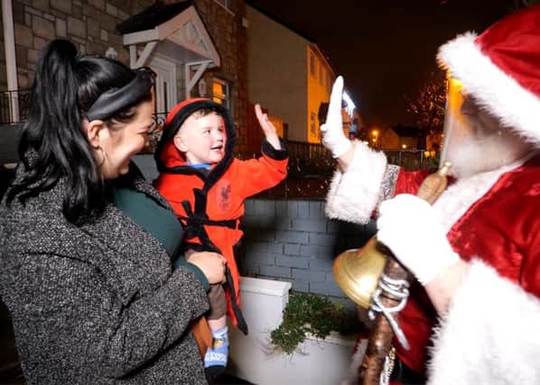 Belfast boy Daithi has been on the heart transplant waiting list for over two years. Here, he gives Santa Clause a high five alongside his mother Seph Ni Mheallain