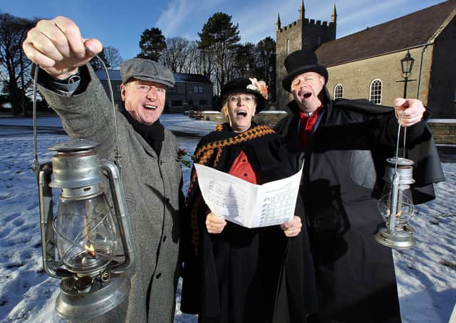 Carollers John Shepherd (left), Ruth Turkington and Victor Sloan (right), practice their favourite Christmas songs ahead of the Ulster Folk and Transport Museum's Spirit of Christmas Past in December 2010. Picture: News Letter archives