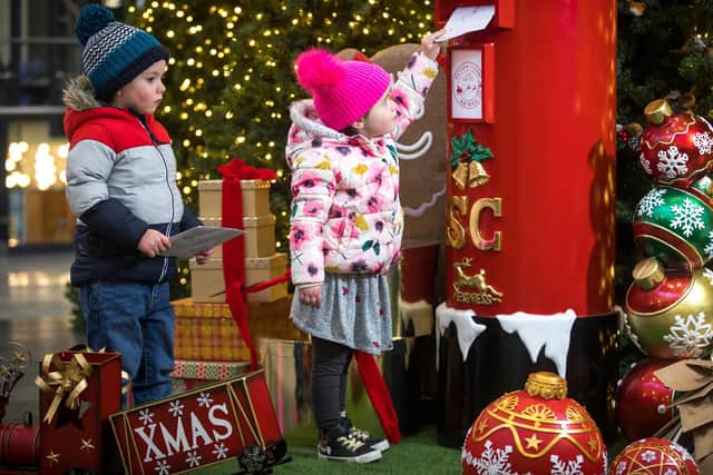 Sophie and Saul Walsh get ready to post their letters at one of the special Santa post boxes in Belfast city centre