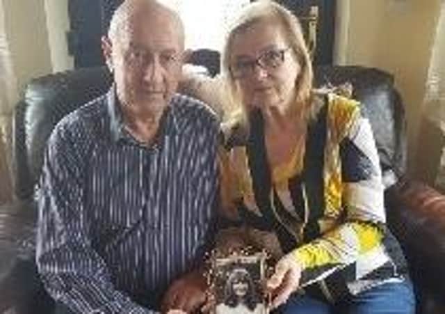 Anthony and O'Reilly and his wife Marie holding a photo of his sister Geraldine, who died in the 1972 loyalist bombing of Belturbet.