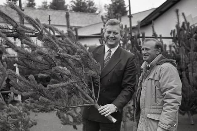 New Ulster Agricultural and Forestry Minister Jeremy Hanley, left of the picture, choosing his own Christmas tree at Belvoir Forest Park on the edge of Belfast in December 1990. He is being advised on the right tree by John McEwan, timber marketing officer with the Forestry Service. Picture: Eddie Harvey/Farming Life/News Letter archives