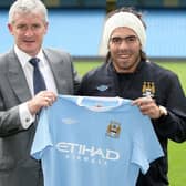 Manchester City manager Mark Hughes with Carlos Tevez in 2009.