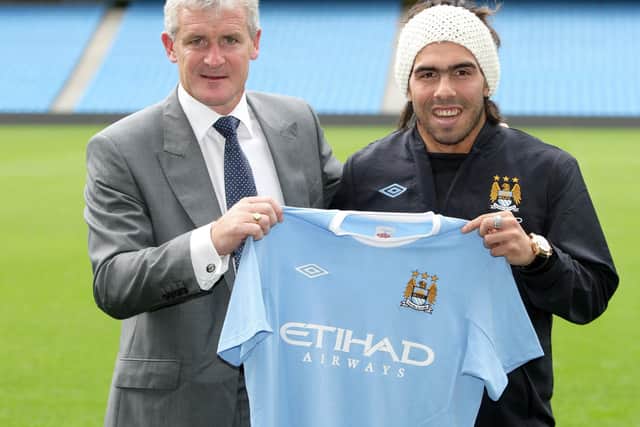 Manchester City manager Mark Hughes with Carlos Tevez in 2009.