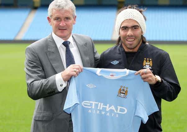 Manchester City manager Mark Hughes with Carlos Tevez in 2009.