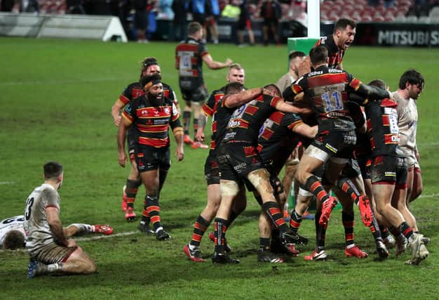 Gloucester's George Barton (hidden) celebrates scoring his side's third try of the game during the Heineken Champions Cup match at the Kingsholm Stadium, Gloucester.