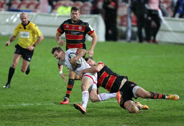 Ulster's Billy Burns is tackled by Gloucester's Mark Atkinson during the Heineken Champions Cup match at the Kingsholm Stadium, Gloucester.