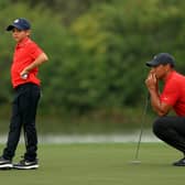 Tiger Woods and son Charlie Woods line up a putt on the 15th hole during the final round of the PNC Championship