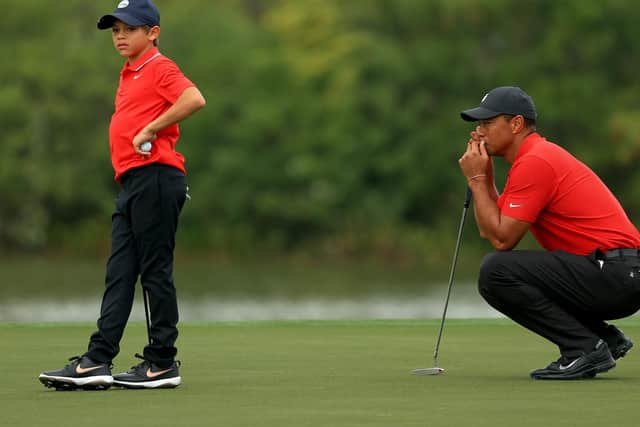 Tiger Woods and son Charlie Woods line up a putt on the 15th hole during the final round of the PNC Championship