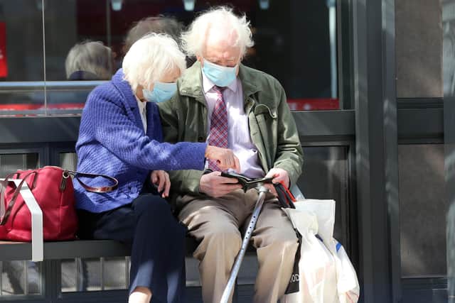 An elderly couple wear face masks as protection against Coronavirus while they wait at a bus stop in Belfast.
Photo: Pacemaker