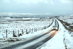 A car makes its way over the Antrim hills in the wintry conditions following Sunday's  snowfall.
PICTURE BY STEPHEN DAVISON